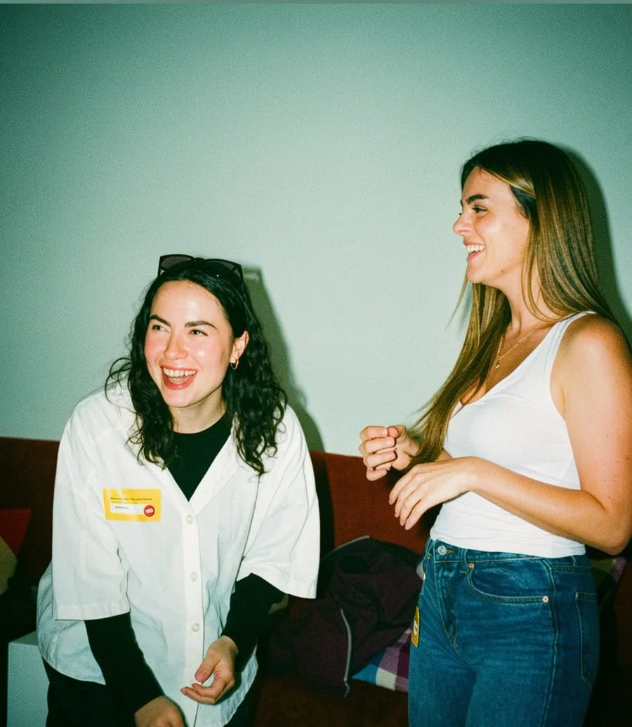 Two people laughing together at a Happy to Gather event